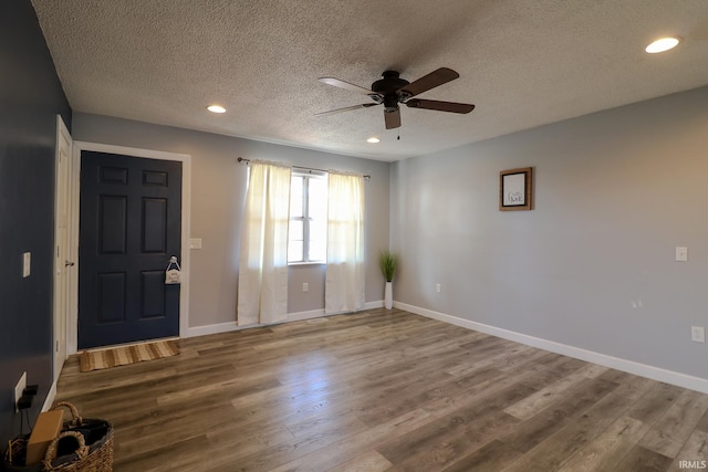 entrance foyer with a textured ceiling, ceiling fan, and wood-type flooring