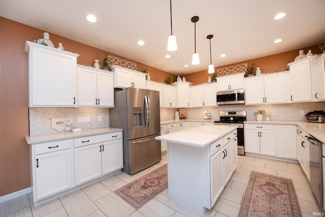 kitchen with stainless steel appliances, backsplash, a kitchen island, pendant lighting, and white cabinets