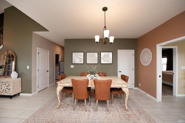 tiled dining space with an inviting chandelier