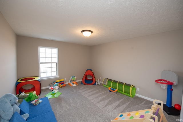 game room featuring a textured ceiling and carpet flooring