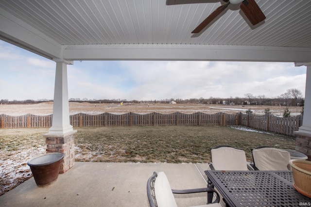 view of patio featuring ceiling fan and a rural view