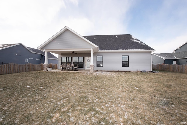 back of property featuring ceiling fan, a patio area, and a yard