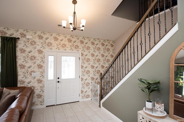 entrance foyer featuring light tile patterned floors and a chandelier