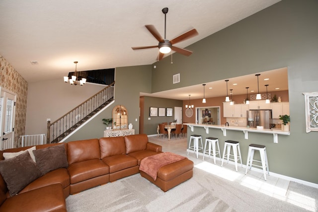 living room featuring light carpet, ceiling fan with notable chandelier, and high vaulted ceiling