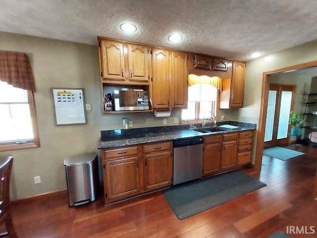 kitchen featuring dark hardwood / wood-style flooring, sink, stainless steel appliances, and a textured ceiling