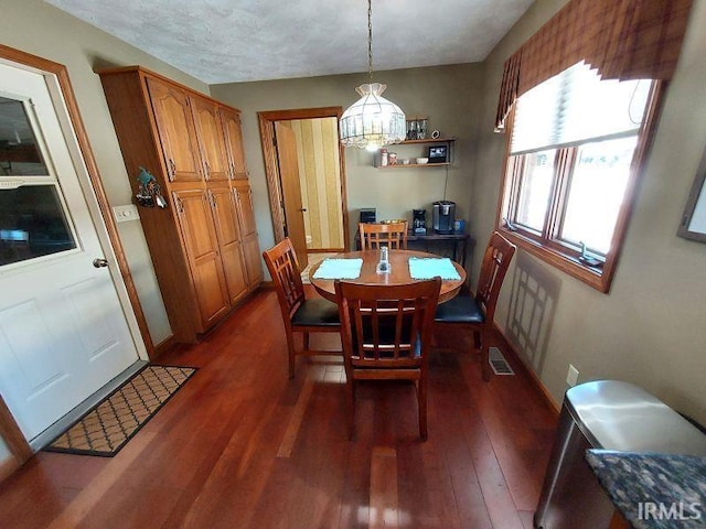 dining space featuring dark hardwood / wood-style flooring