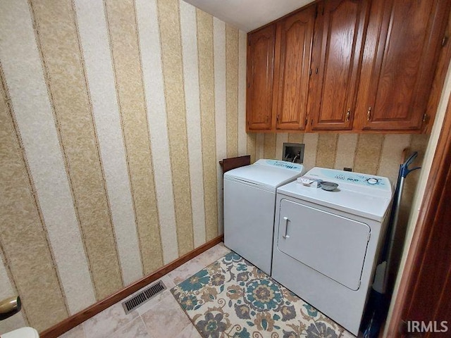 laundry area with light tile patterned flooring, separate washer and dryer, and cabinets