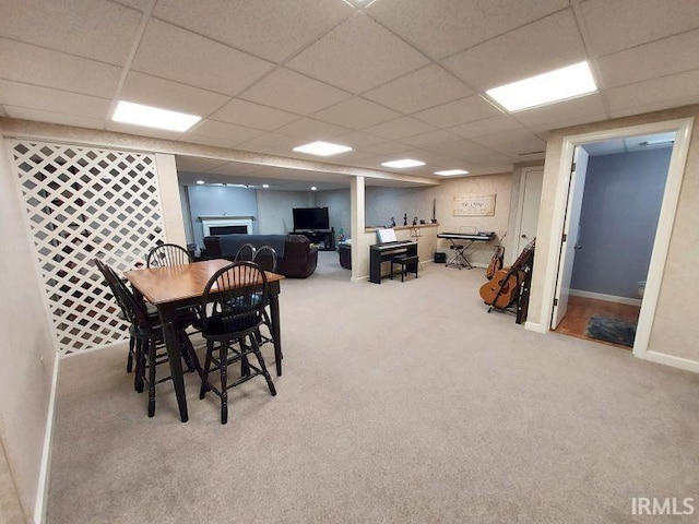 dining space featuring a drop ceiling and carpet floors