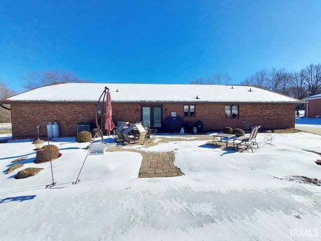 view of snow covered back of property