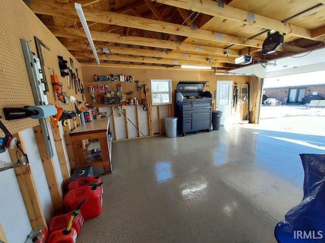 garage with a workshop area and a garage door opener