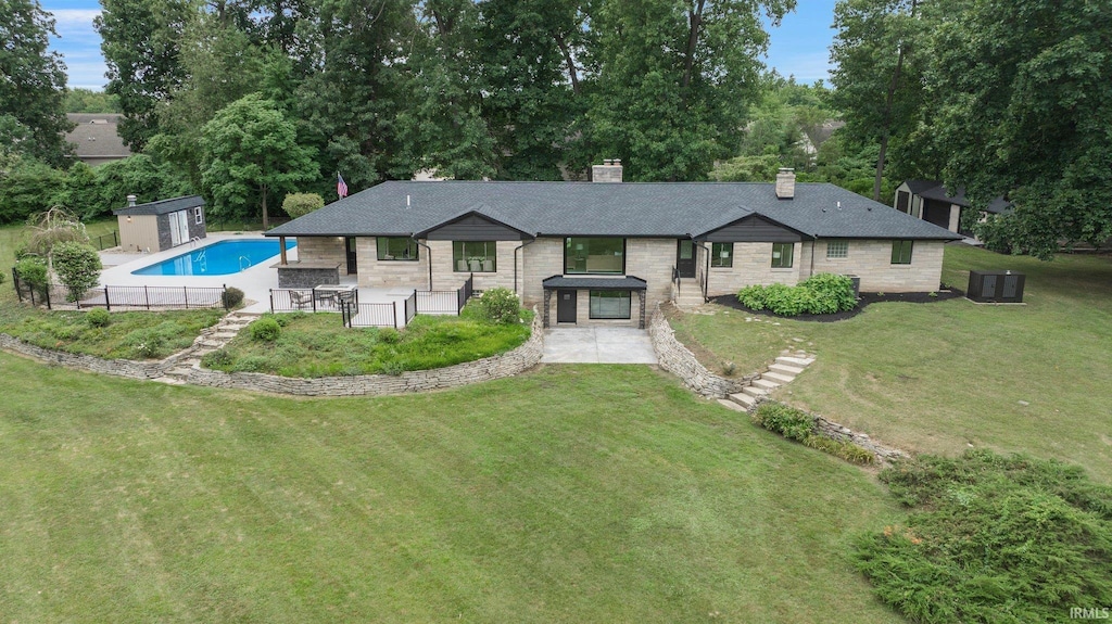 exterior space with a front lawn, central AC unit, a storage unit, and a patio area