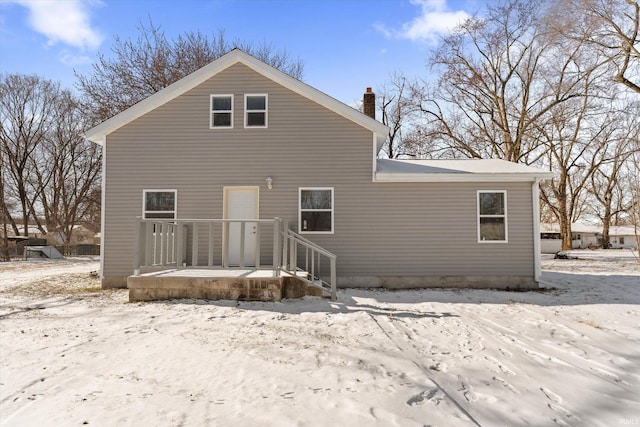 view of snow covered rear of property