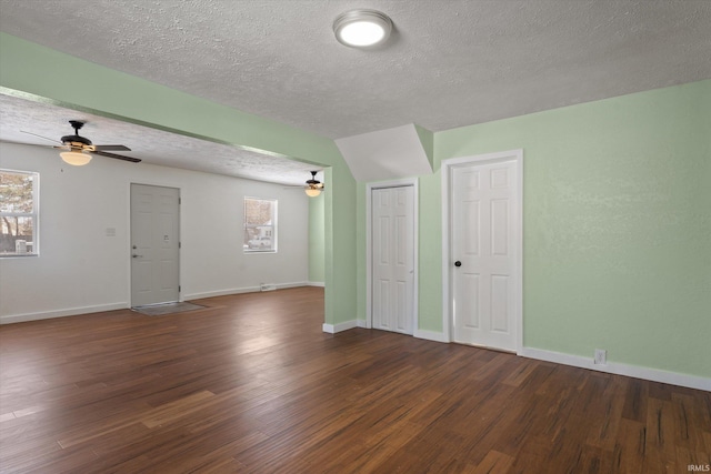 spare room with ceiling fan, dark hardwood / wood-style floors, and a textured ceiling