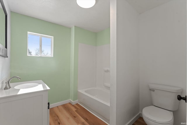 full bathroom featuring toilet, vanity, tub / shower combination, and hardwood / wood-style floors