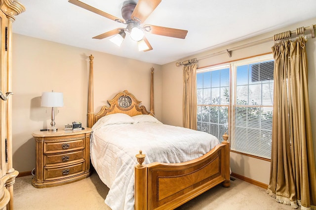 bedroom featuring light carpet and ceiling fan