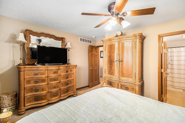 bedroom with ensuite bathroom and ceiling fan