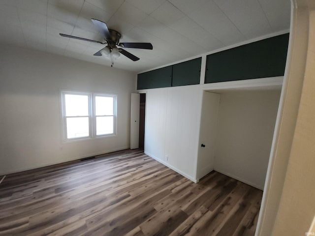 unfurnished bedroom featuring dark hardwood / wood-style floors and ceiling fan