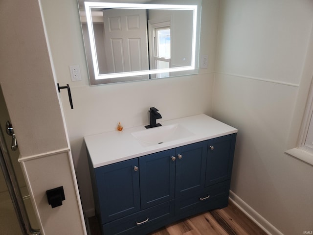 bathroom with hardwood / wood-style flooring and vanity