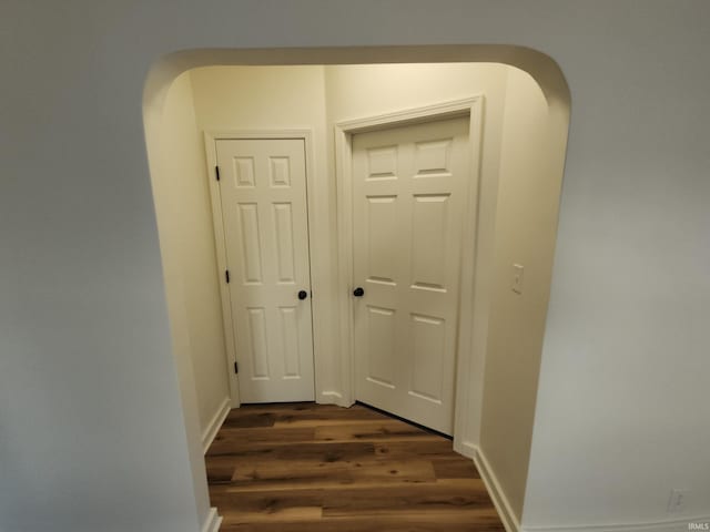 corridor featuring dark hardwood / wood-style floors