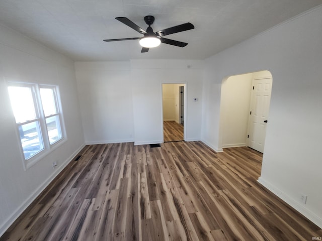 empty room featuring ceiling fan and dark hardwood / wood-style flooring