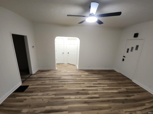 empty room featuring dark hardwood / wood-style flooring and ceiling fan