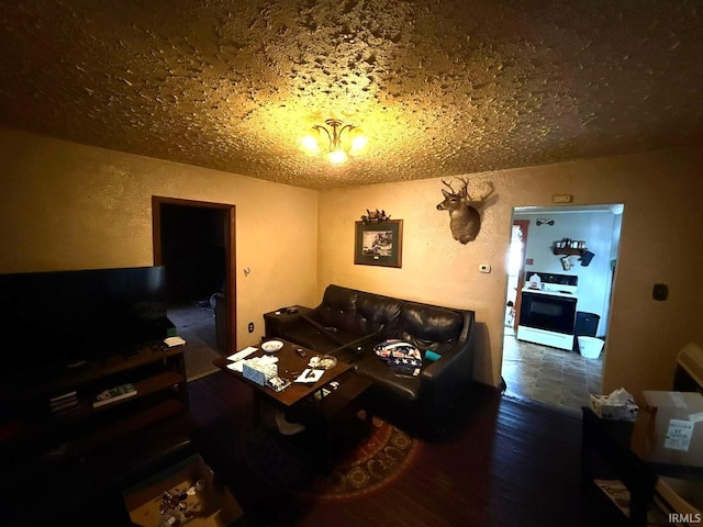 living room with a chandelier, a textured ceiling, and hardwood / wood-style floors