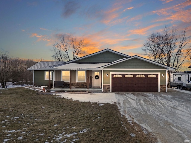 view of front of home with a garage and a lawn