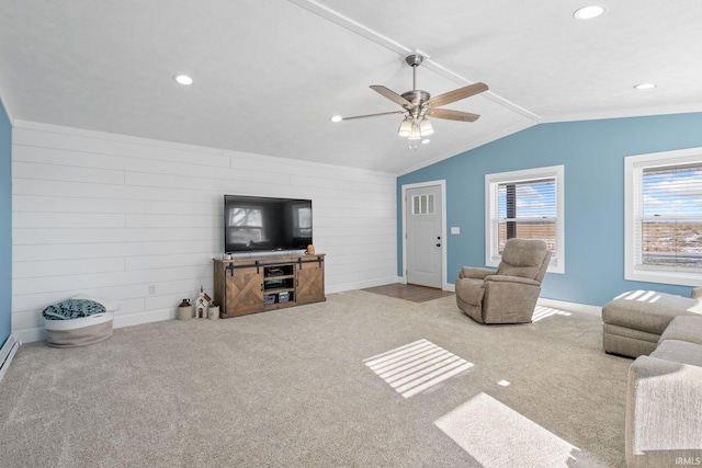 living room with vaulted ceiling, ceiling fan, light colored carpet, and wood walls