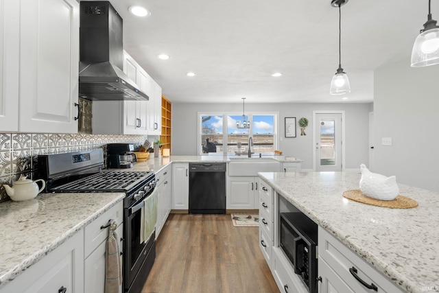 kitchen featuring range hood, white cabinets, backsplash, and black appliances