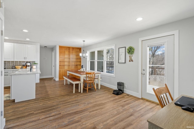 dining area with a chandelier and hardwood / wood-style flooring