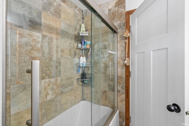 bathroom featuring bath / shower combo with glass door