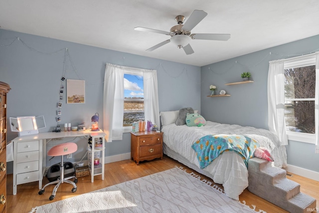 bedroom with ceiling fan and light hardwood / wood-style floors