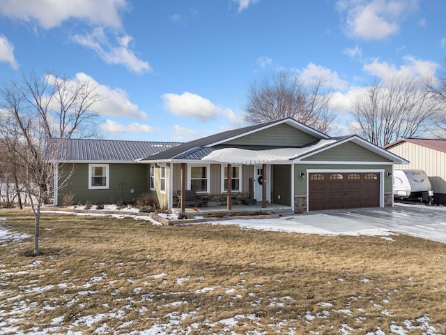 single story home featuring a garage, a yard, and a porch