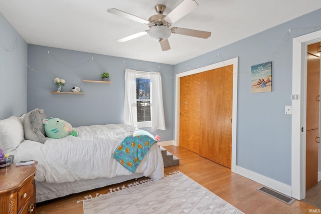 bedroom featuring ceiling fan, a closet, and hardwood / wood-style floors