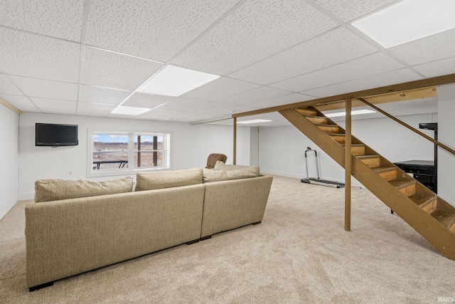 living room with a paneled ceiling and carpet floors