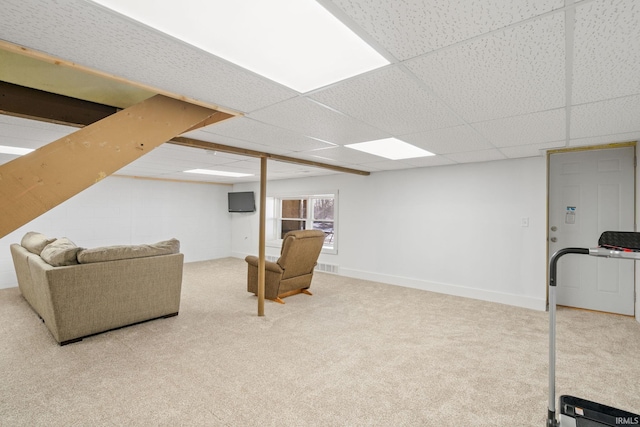 basement with carpet and a paneled ceiling