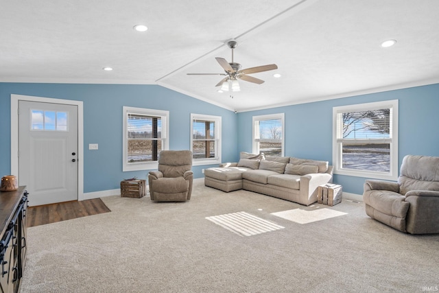 living room with carpet floors, ceiling fan, a wealth of natural light, and lofted ceiling