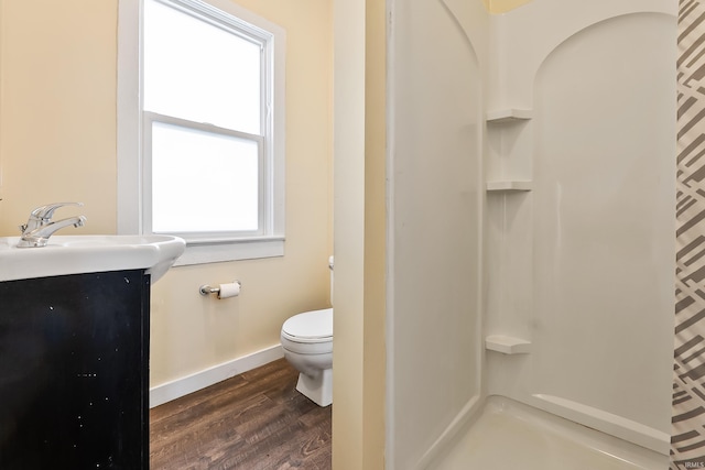 bathroom with toilet, walk in shower, wood-type flooring, and vanity