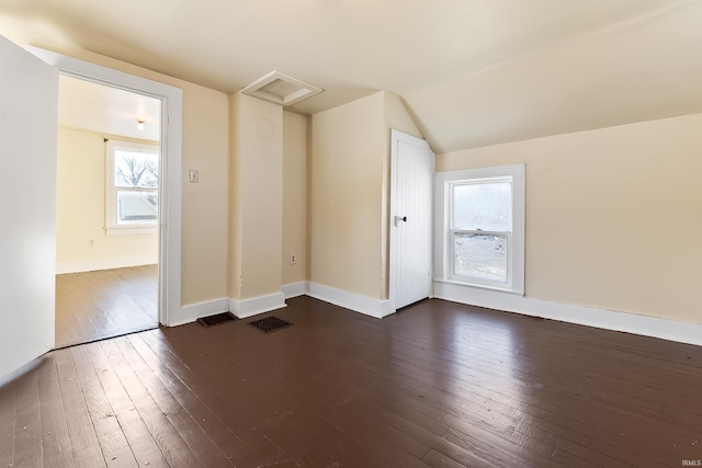 bonus room featuring vaulted ceiling and dark hardwood / wood-style floors