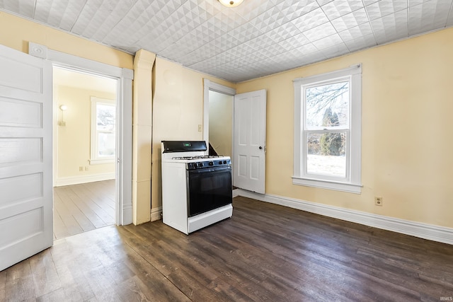 kitchen featuring dark hardwood / wood-style flooring and white gas range oven