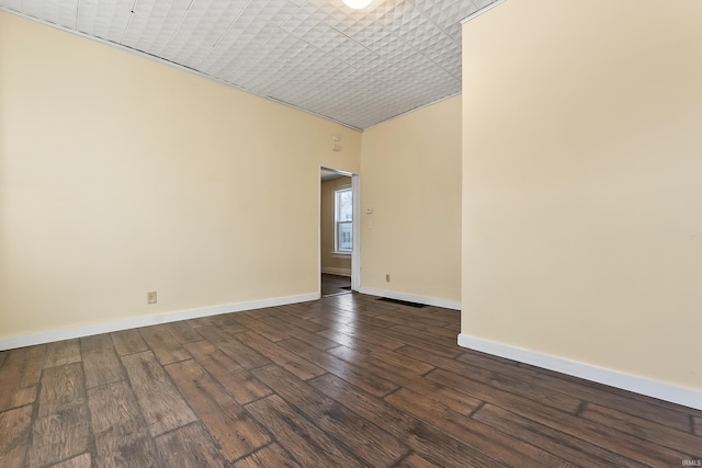 empty room featuring dark hardwood / wood-style flooring