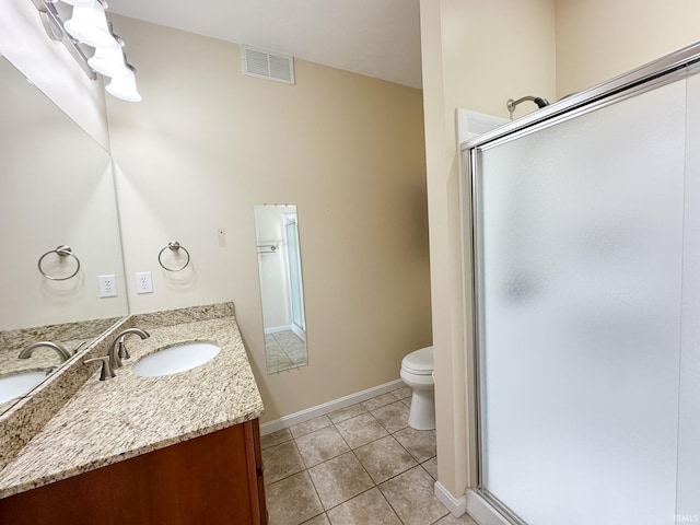 bathroom featuring walk in shower, vanity, tile patterned flooring, and toilet