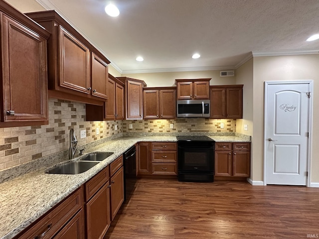 kitchen featuring black appliances, decorative backsplash, sink, dark hardwood / wood-style floors, and ornamental molding