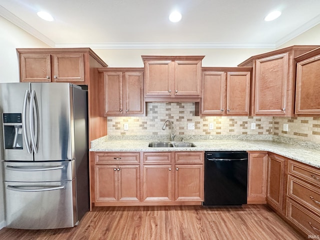 kitchen featuring backsplash, dishwasher, sink, crown molding, and stainless steel fridge