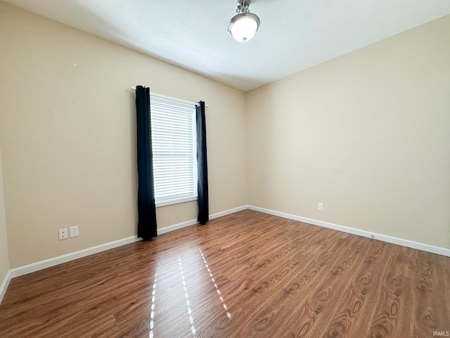 unfurnished room featuring hardwood / wood-style flooring