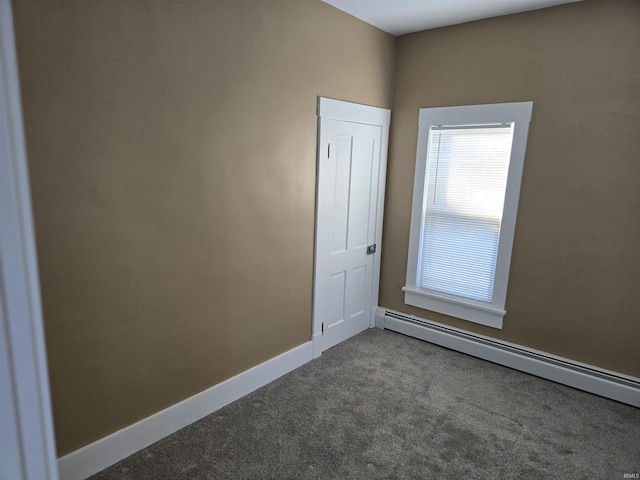 spare room featuring carpet floors and baseboard heating