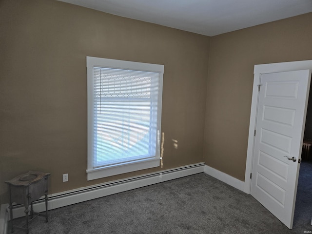 carpeted spare room featuring baseboard heating and radiator