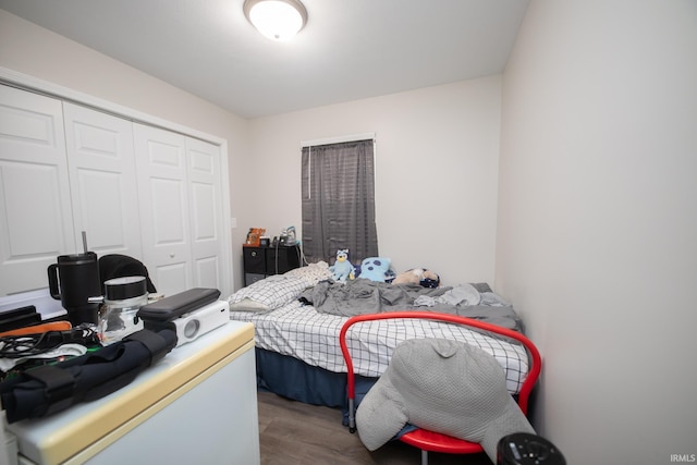 bedroom with a closet and hardwood / wood-style floors