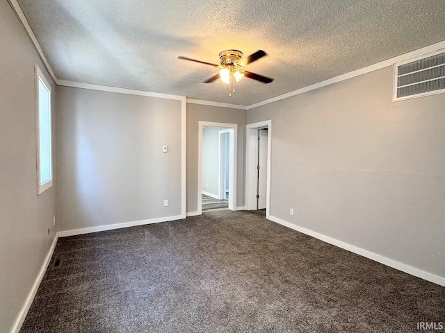 carpeted spare room with crown molding, ceiling fan, and a textured ceiling