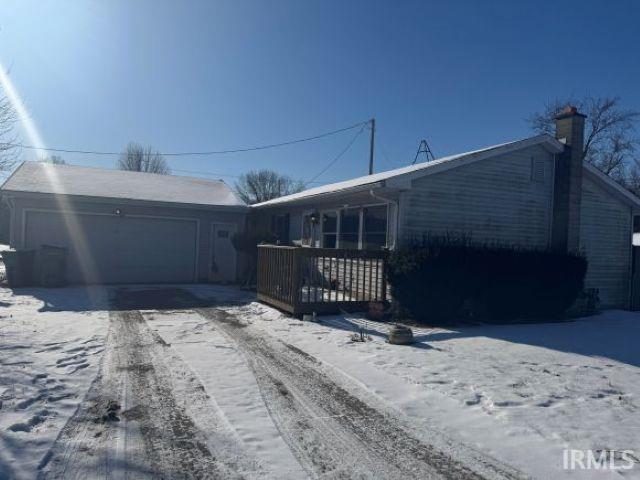 view of front of house featuring a garage and a wooden deck